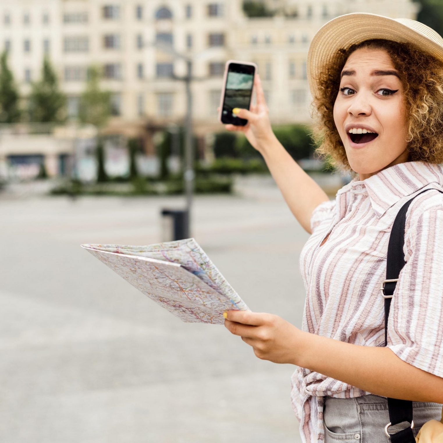 shocked-woman-holding-map-phone shocked-woman-holding-map-phone
